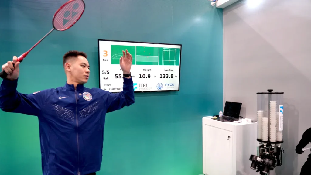 badminton coach using technology and data analysis during training session in 2025
