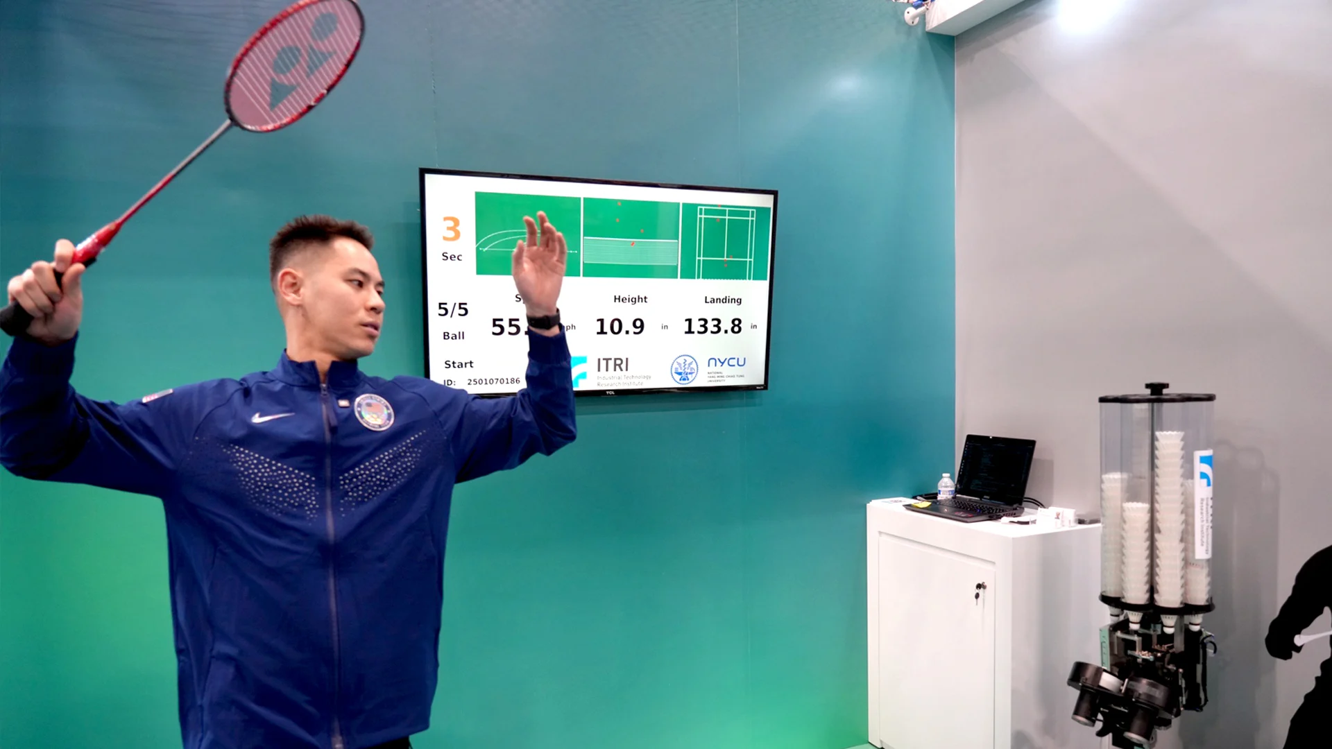 badminton coach using technology and data analysis during training session in 2025